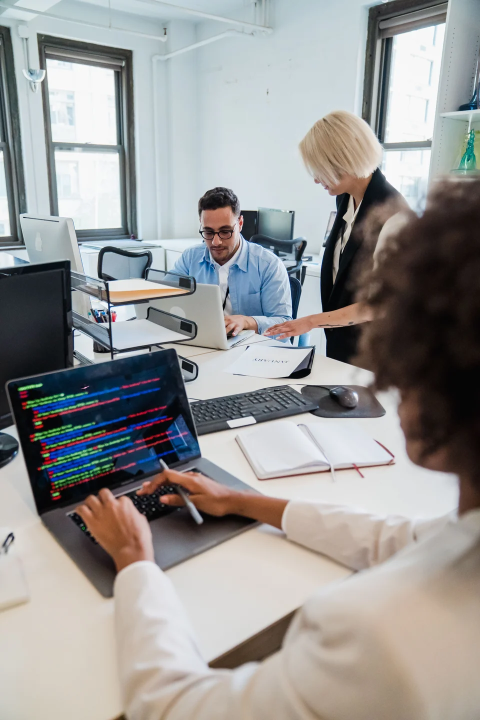 Colleagues reviewing a software project together at a desk